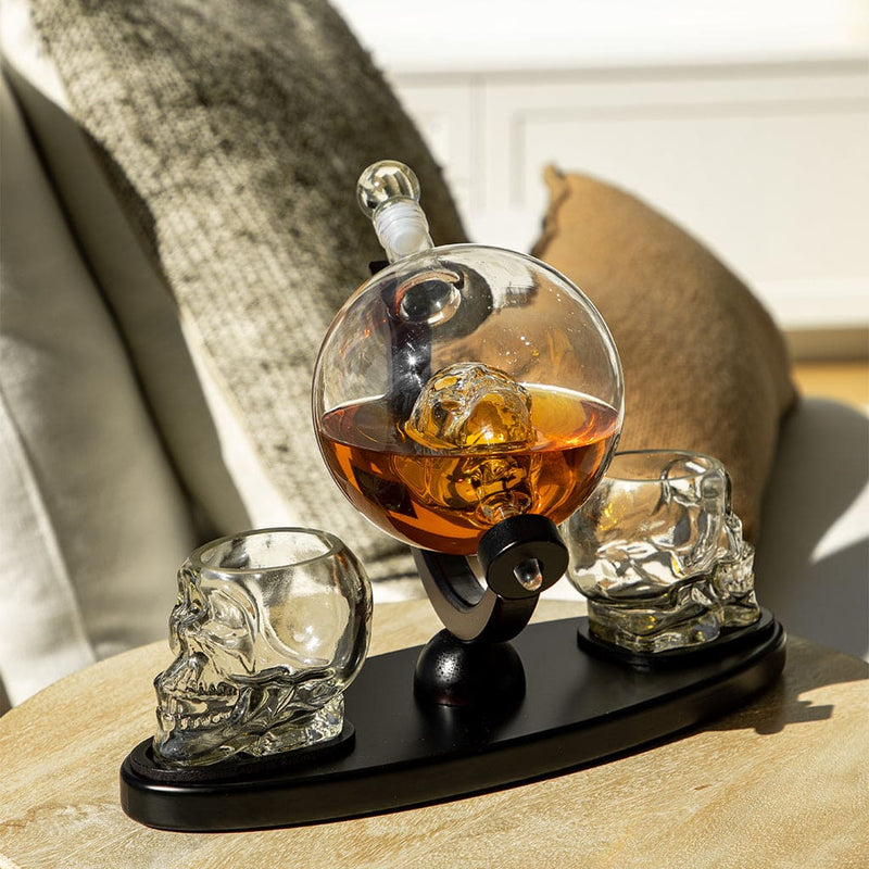 Don Vassie skull decanter set with 2 glasses and mahogany base .